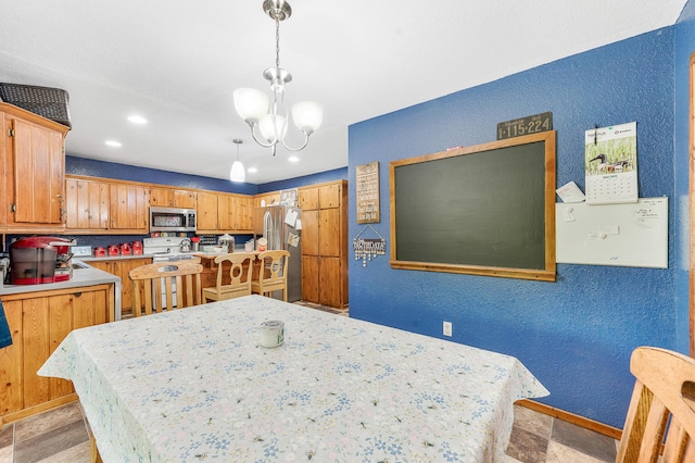22251 210th Ave, Tustin, MI 49688 - dining room featuring a textured wall, a chandelier, recessed lighting, and baseboards