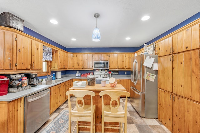 22251 210th Ave, Tustin, MI 49688 - kitchen with appliances with stainless steel finishes, a sink, light countertops, recessed lighting, and decorative light fixtures