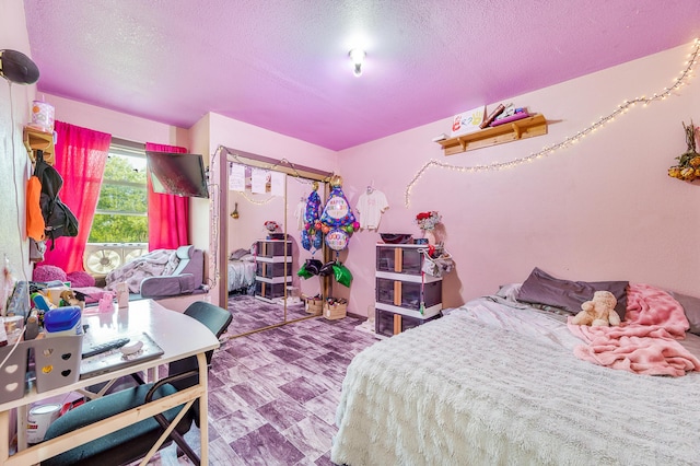 22251 210th Ave, Tustin, MI 49688 - bedroom with a textured ceiling and tile patterned floors