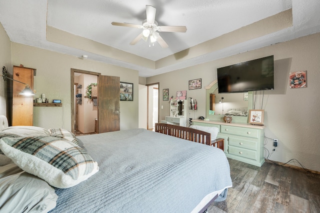 22251 210th Ave, Tustin, MI 49688 - bedroom with a raised ceiling, wood finished floors, and a ceiling fan
