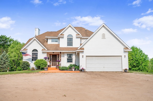 22251 210th Ave, Tustin, MI 49688 - traditional home featuring driveway, a chimney, a shingled roof, a garage, and covered porch