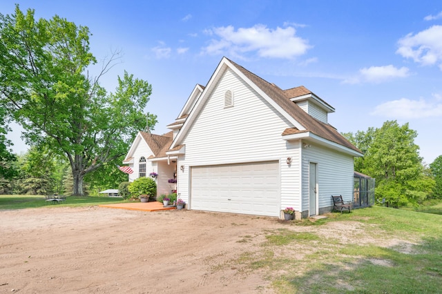 22251 210th Ave, Tustin, MI 49688 - view of side of home with dirt driveway and a lawn