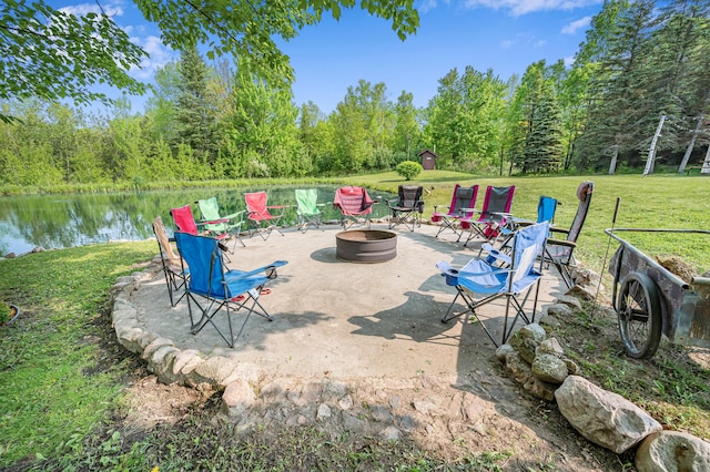 22251 210th Ave, Tustin, MI 49688 - view of patio / terrace with an outdoor fire pit, a water view, and a forest view