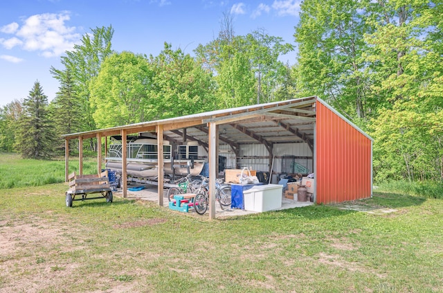 22251 210th Ave, Tustin, MI 49688 - view of pole building featuring a carport and a yard