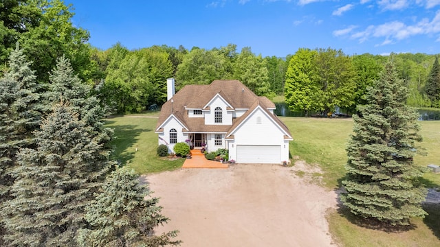 22251 210th Ave, Tustin, MI 49688 - view of front of home featuring driveway, a front lawn, a porch, a chimney, and a forest view
