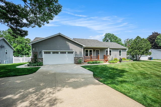 171 Arnold St, Allegan, MI 49010 - single story home with a porch, concrete driveway, an attached garage, and stone siding