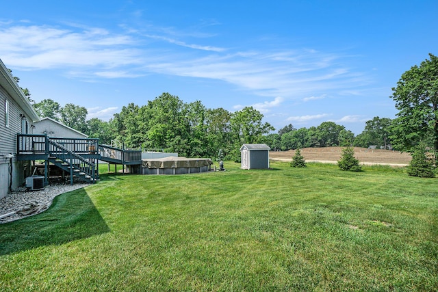 171 Arnold St, Allegan, MI 49010 - view of grassy yard with stairway, a deck, and an outdoor pool