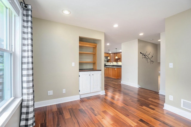 171 Arnold St, Allegan, MI 49010 - empty room featuring dark wood-style flooring, recessed lighting, and baseboards
