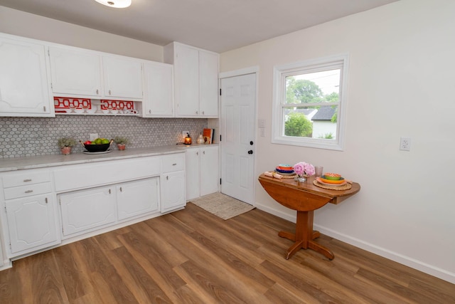 1802 Ferry St, Niles, MI 49120 - kitchen featuring backsplash, white cabinetry, wood finished floors, and light countertops