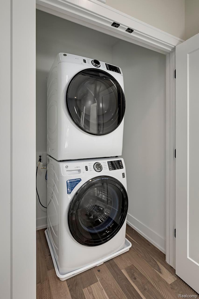 3634 Trumbull St Unit 65, Detroit, MI 48208 - washroom with estacked washer and dryer, wood finished floors, and baseboards