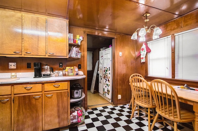 204 Clinton St, Dowagiac, MI 49047 - kitchen featuring tile patterned floors, light countertops, wooden walls, open shelves, and brown cabinets