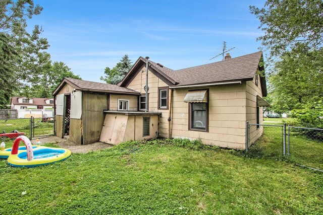 204 Clinton St, Dowagiac, MI 49047 - back of property with a gate and roof with shingles