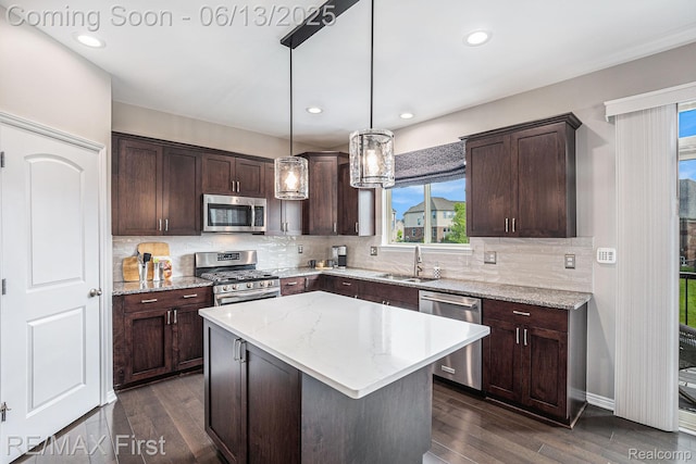 17769 Tiger Dr, Macomb, MI 48042 - kitchen with appliances with stainless steel finishes, dark brown cabinetry, dark wood-type flooring, backsplash, and recessed lighting