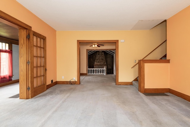 3804 Portage St, Kalamazoo, MI 49001 - unfurnished living room featuring carpet flooring, stairs, and a ceiling fan
