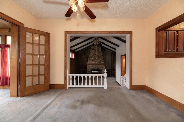 3804 Portage St, Kalamazoo, MI 49001 - unfurnished living room with a textured ceiling, carpet, a ceiling fan, a textured wall, and vaulted ceiling