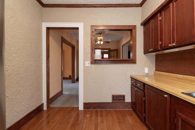 3804 Portage St, Kalamazoo, MI 49001 - bar with a textured wall, wood finished floors, ceiling fan, and crown molding