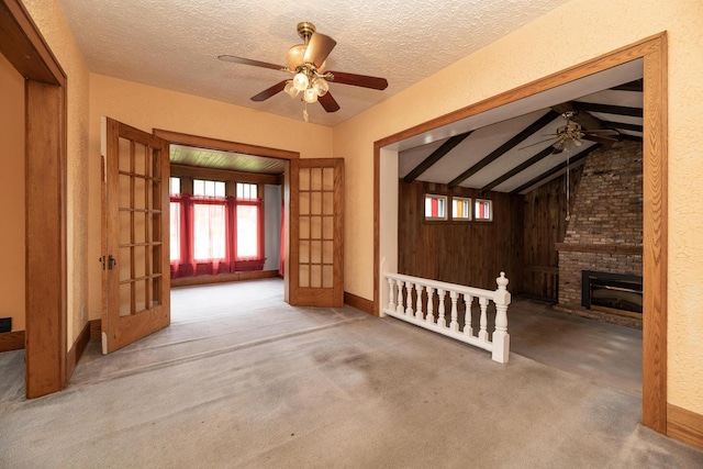 3804 Portage St, Kalamazoo, MI 49001 - unfurnished living room featuring a ceiling fan, healthy amount of natural light, french doors, and a textured ceiling