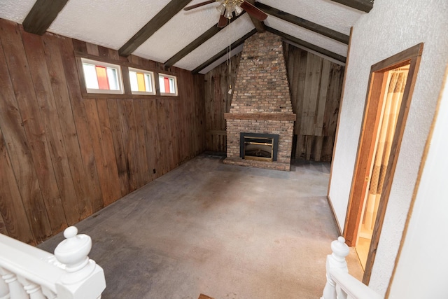 3804 Portage St, Kalamazoo, MI 49001 - unfurnished living room featuring wooden walls, a ceiling fan, a brick fireplace, carpet flooring, and a textured ceiling