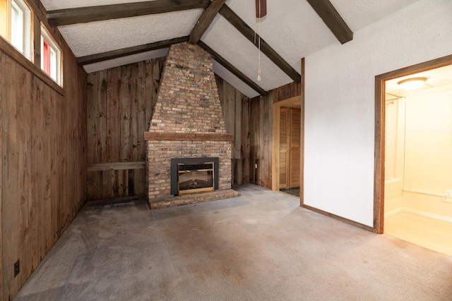 3804 Portage St, Kalamazoo, MI 49001 - unfurnished living room with wood walls, a fireplace, a textured ceiling, and carpet floors