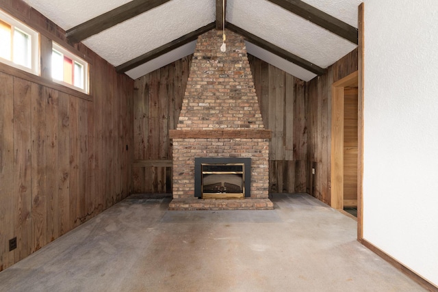 3804 Portage St, Kalamazoo, MI 49001 - unfurnished living room with wooden walls, carpet floors, a fireplace, and a textured ceiling