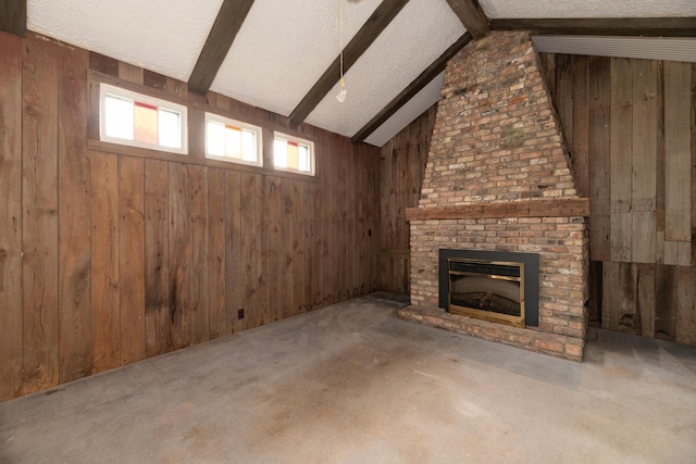 3804 Portage St, Kalamazoo, MI 49001 - unfurnished living room featuring wood walls, a brick fireplace, a textured ceiling, and carpet flooring