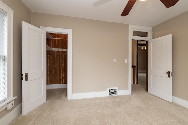 3804 Portage St, Kalamazoo, MI 49001 - unfurnished bedroom featuring carpet, a spacious closet, and a ceiling fan