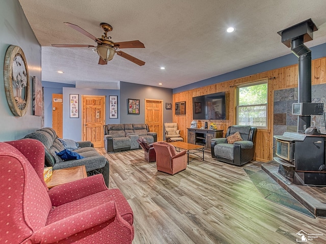 9601 Exeter Rd, Carleton, MI 48117 - living area with a wood stove, wood finished floors, ceiling fan, a textured ceiling, and recessed lighting