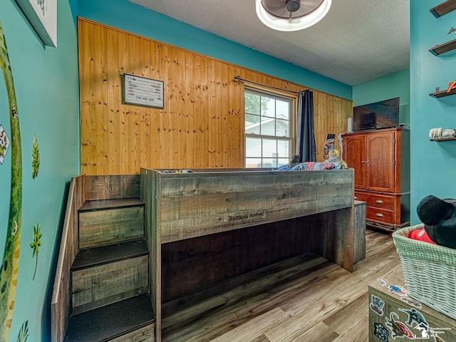 9601 Exeter Rd, Carleton, MI 48117 - misc room featuring wood finished floors, a textured ceiling, and wooden walls