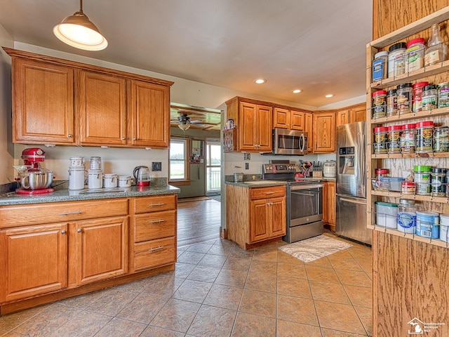 9601 Exeter Rd, Carleton, MI 48117 - kitchen featuring appliances with stainless steel finishes, brown cabinetry, recessed lighting, hanging light fixtures, and light tile patterned floors