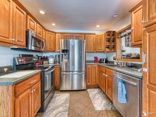 9601 Exeter Rd, Carleton, MI 48117 - kitchen featuring stainless steel appliances, light tile patterned flooring, brown cabinetry, and recessed lighting