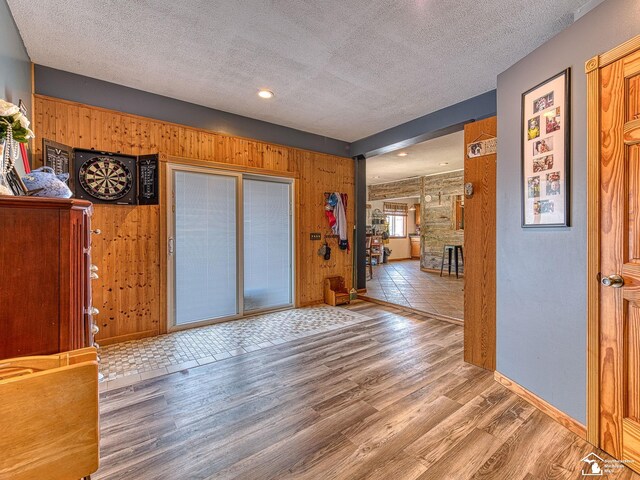 9601 Exeter Rd, Carleton, MI 48117 - foyer featuring a textured ceiling, wood finished floors, wooden walls, baseboards, and recessed lighting