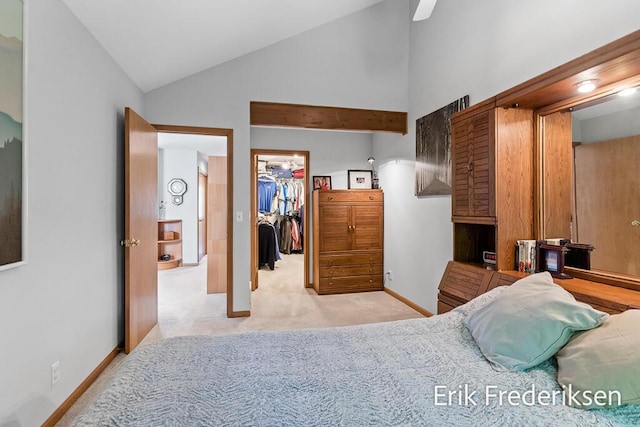 17879 Hidden Dunes Ln Unit D, Spring Lake, MI 49456 - bedroom featuring light carpet, a walk in closet, lofted ceiling, a closet, and baseboards