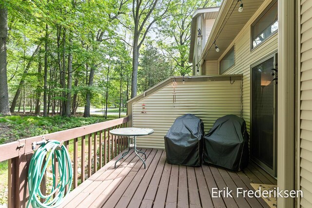 17879 Hidden Dunes Ln Unit D, Spring Lake, MI 49456 - deck with view of wooded area and a grill