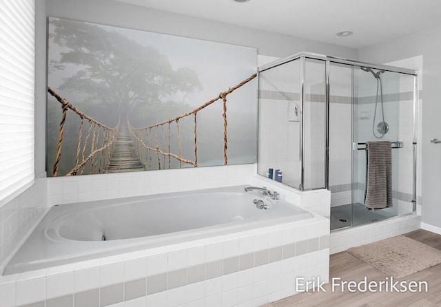 17879 Hidden Dunes Ln Unit D, Spring Lake, MI 49456 - bathroom featuring a garden tub, a shower stall, and wood finished floors