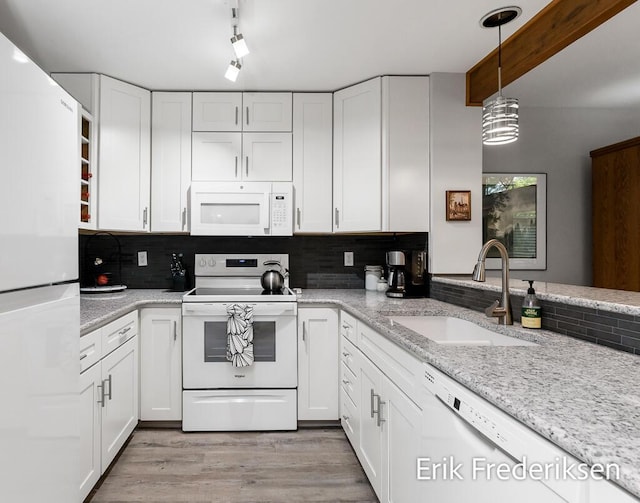 17879 Hidden Dunes Ln Unit D, Spring Lake, MI 49456 - kitchen featuring white appliances, a sink, white cabinets, decorative backsplash, and light wood-style flooring