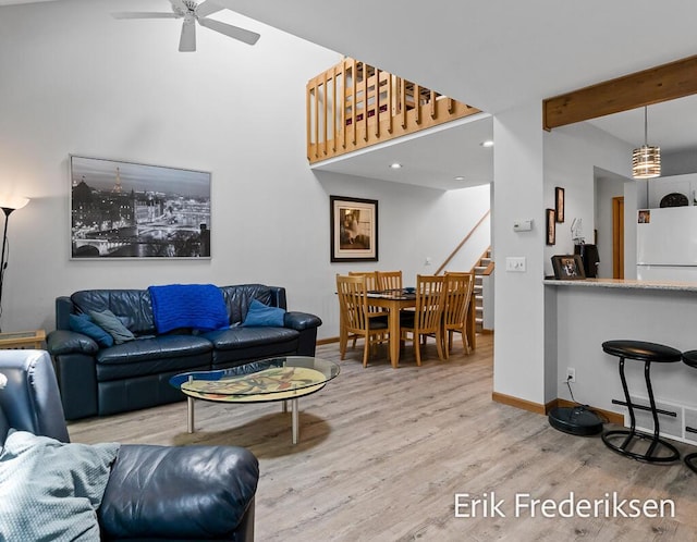 17879 Hidden Dunes Ln Unit D, Spring Lake, MI 49456 - living room with wood finished floors, stairs, ceiling fan, baseboards, and beamed ceiling