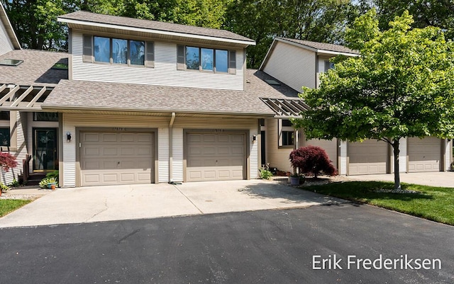 17879 Hidden Dunes Ln Unit D, Spring Lake, MI 49456 - view of property with a shingled roof, concrete driveway, and an attached garage
