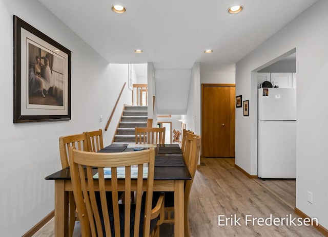 17879 Hidden Dunes Ln Unit D, Spring Lake, MI 49456 - dining space featuring light wood-style floors, recessed lighting, baseboards, and stairs