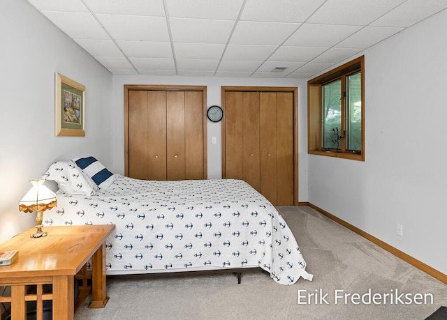 17879 Hidden Dunes Ln Unit D, Spring Lake, MI 49456 - bedroom featuring multiple closets, carpet floors, baseboards, and a drop ceiling