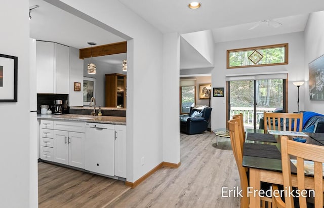 17879 Hidden Dunes Ln Unit D, Spring Lake, MI 49456 - kitchen with white dishwasher, healthy amount of natural light, and light wood-style floors