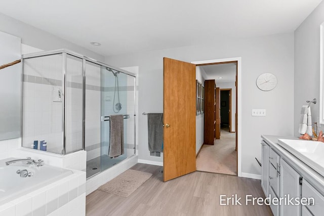 17879 Hidden Dunes Ln Unit D, Spring Lake, MI 49456 - full bathroom featuring a shower stall, vanity, wood finished floors, and a garden tub