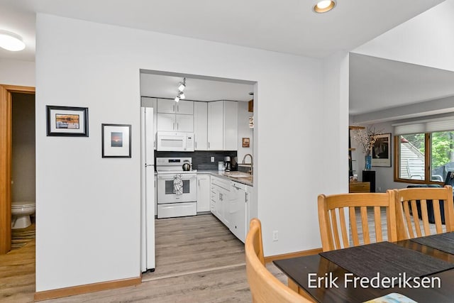17879 Hidden Dunes Ln Unit D, Spring Lake, MI 49456 - kitchen featuring white appliances, white cabinetry, light wood-style flooring, tasteful backsplash, and recessed lighting