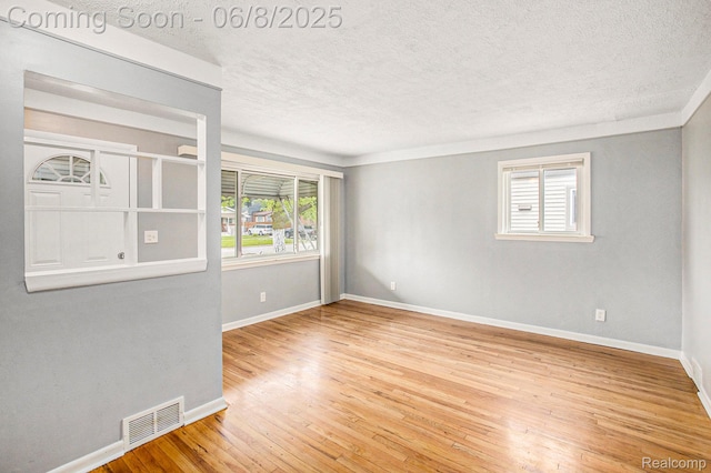 7612 Clippert St, Taylor, MI 48180 - empty room featuring a textured ceiling, baseboards, and wood finished floors
