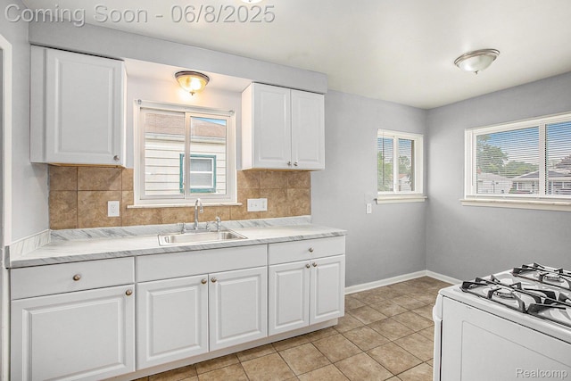 7612 Clippert St, Taylor, MI 48180 - kitchen featuring a sink, backsplash, white range with gas cooktop, light tile patterned floors, and light countertops