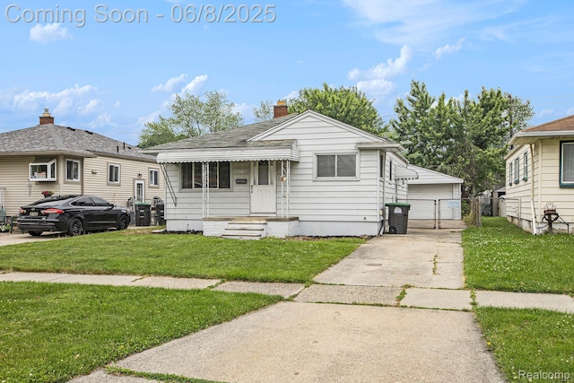 7612 Clippert St, Taylor, MI 48180 - view of front facade with a gate, a chimney, a garage, and an outbuilding