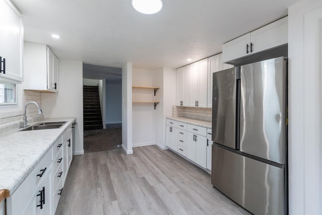15551 Mason St, Union, MI 49130 - kitchen featuring freestanding refrigerator, a sink, tasteful backsplash, light wood-type flooring, and light countertops