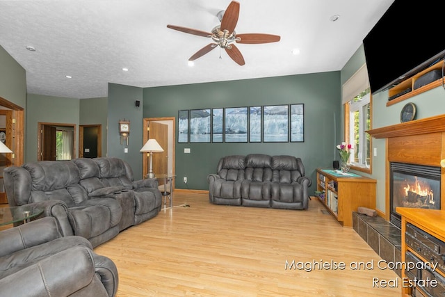4349 Walter Rd, Wayland, MI 49348 - living area featuring wood finished floors, ceiling fan, a tile fireplace, and recessed lighting