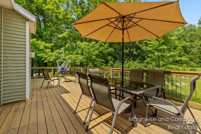 4349 Walter Rd, Wayland, MI 49348 - deck with outdoor dining area and view of scattered trees