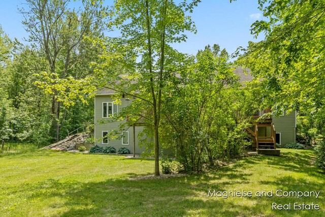 4349 Walter Rd, Wayland, MI 49348 - view of grassy yard with stairway and a wooden deck