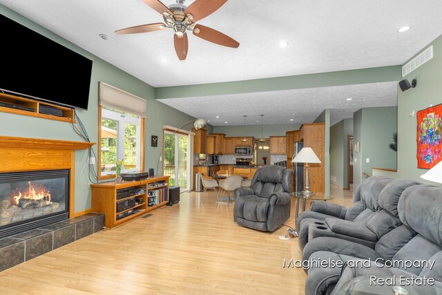 4349 Walter Rd, Wayland, MI 49348 - living area with light wood-type flooring, a ceiling fan, recessed lighting, and a fireplace